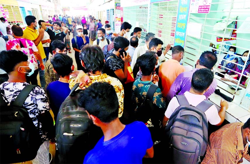 Passengers cram the Gabtoli Bus Termanal in the capital on Sunday to go homes in order to spend Eid holidays with their near and dear ones.