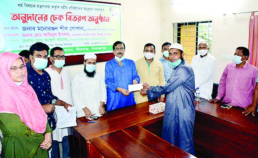 Monoranjan Shil Gopal, MP from Dinajpur -1 constituency distributes cheques of donation aming different religious organizations of Birganj upazila of Dinajpur provided by the Ministry of Religious Affairs at a formal ceremony at the Upazila Parishad Hall