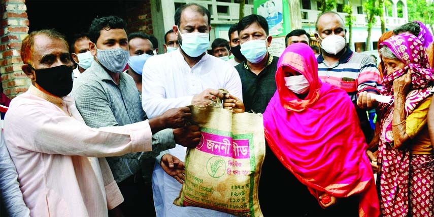 Chairman of Bogura Kagoil Union under Gabtoli upazila, Aga Nehal Bin Jalil Tapon distributes 10 kg of rice each among one thousand 230 people of the union allotted by the Relief Ministry on the occasion of Eid and Corona pandemic at a distribution program