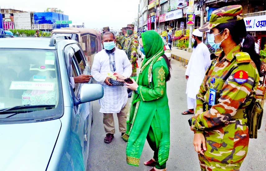 Army personnel check people's movement from a check post during the 'strict lockdown' in the capital on Friday.