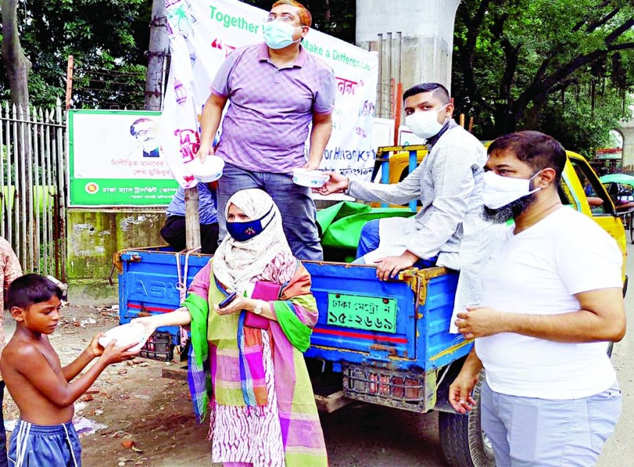 President of Krishibid Foundation for Humanity's Eid Ananda Programme Dilruba Bedana distributes foodstuff among the destitute in the city's Gandaria area on Saturday.