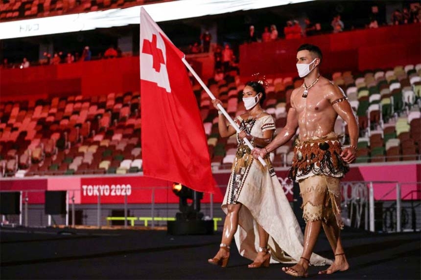 Tonga's flag bearers Malia Paseka (left) and Pita Taufatofua lead the delegation during the Tokyo 2020 Olympic Games opening ceremony.