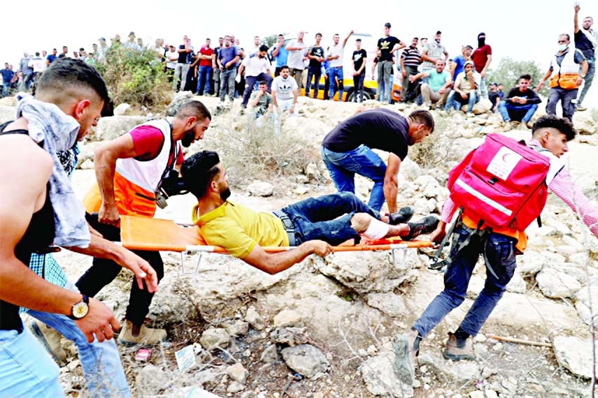 Medics evacuate an injured Palestinian protester amid confrontations with Israeli security forces during a demonstration in the town of Beita near Nablus city in the occupied West Bank.