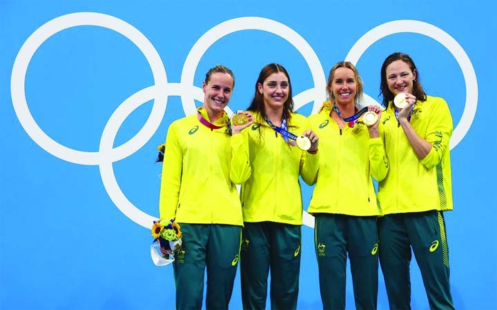 (From left to right) Gold medalists Emma McKeon of Australia, Meg Harris of Australia, Cate Campbell of Australia and Bronte Campbell of Australia celebrate on the podium during the Tokyo 2020 Olympics Swimming Women's 4 x 100m Freestyle Relay at Tokyo