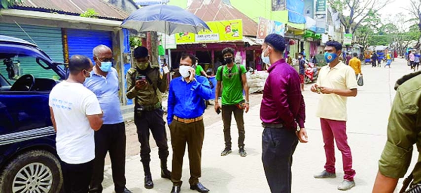 Brahmanbaria Bijoynagar UNO and Executive Magistrate KM Yasir Arafat conducts a mobile courts to ensure compliance with strict restrictions and hygiene rules announced by the government to combat corona outbreak at various points of the upazila including