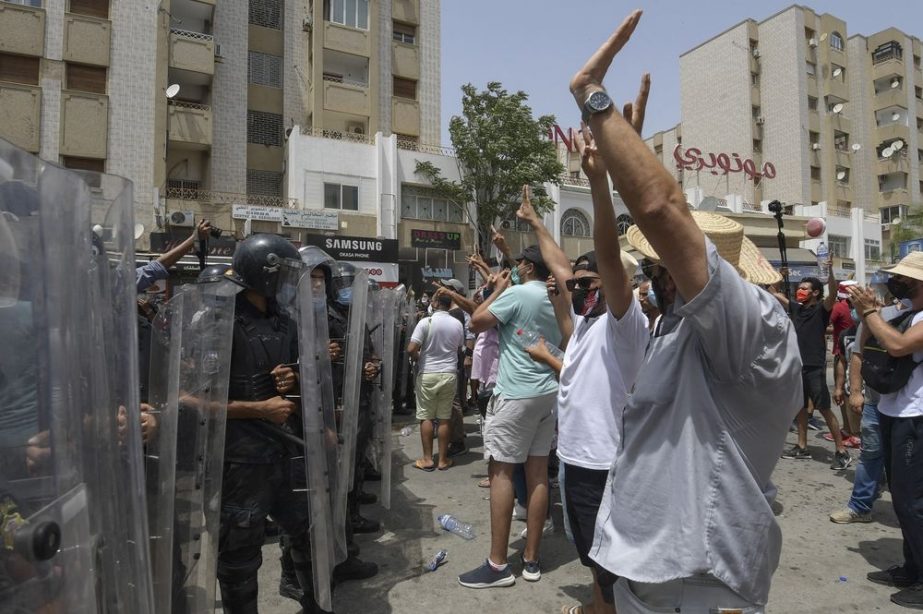 Members of Tunisian security forces face off with anti-government demonstrators during a rally in front of the Parliament in the capital Tunis on July 25.