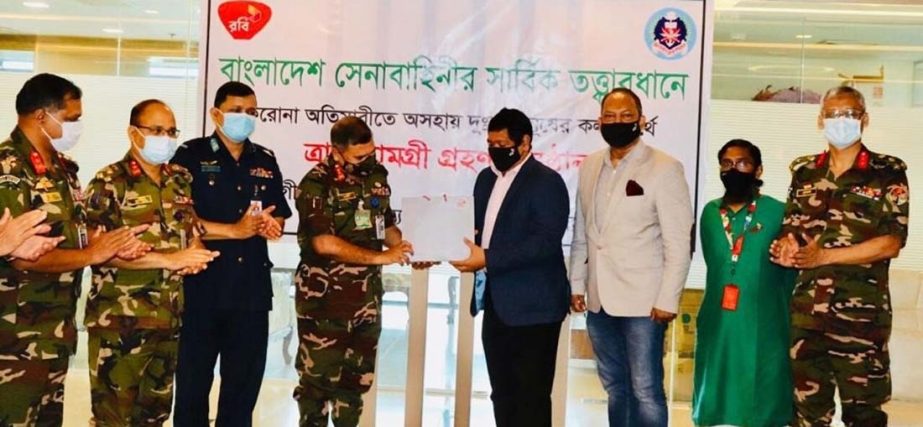 Shahed Alam, Chief Corporate and Regulatory Officer of Robi, handing over a significant number of packets comprised with essential food items to Major General Mohammed Saidul Islam, Chairman of Sena Kalyan Sangstha (SKS) for underprivileged people affecte