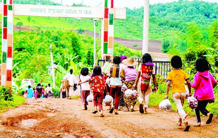 People carry food aid distributed by a volunteer group in Pankai village in Kutkai township in Myanmar's eastern Shan state.