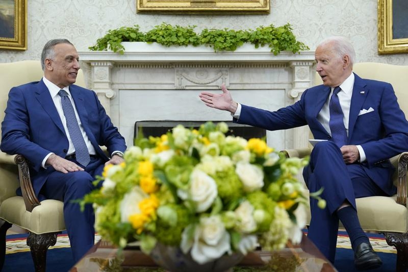 President Joe Biden, right, speaks as Iraqi Prime Minister Mustafa al-Kadhimi, left, listens during their meeting in the Oval Office of the White House in Washington, Monday, July 26, 2021.