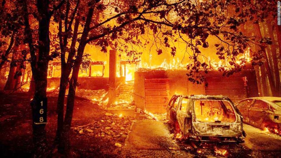 Flames consume a home as the Dixie Fire tears through the Indian Falls community of Plumas County, California.