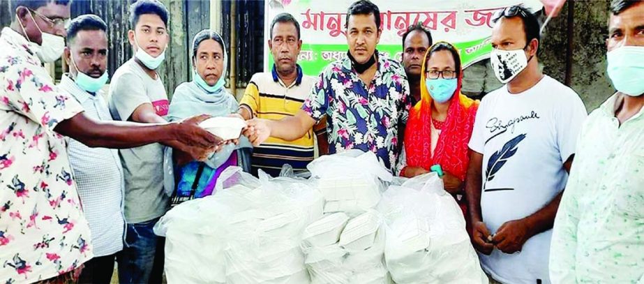 Prof Dr Md. Abdul Aziz, MP from Sirajganj-3 (Tarash-Raiganj) constituencies distributes food among the poor people of the locality at Tarash University College Gate on Wednesday. NN photo