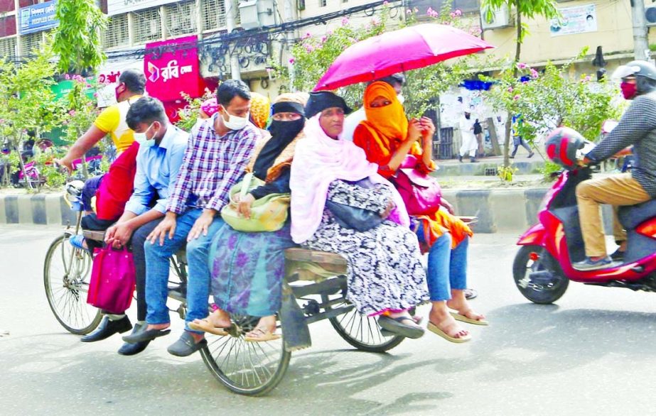 Showing various excuses the people are coming out of their houses defying Covid restriction amid surge of infection. This photo taken from Motijheel in the capital on Wednesday shows a number of people boarding a rickshaw van without following health guid