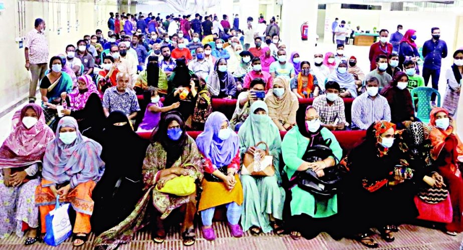 Commoners crowd hospital to receive corona vaccine. The snap was taken from Dhaka Medical College Hospital on Saturday.