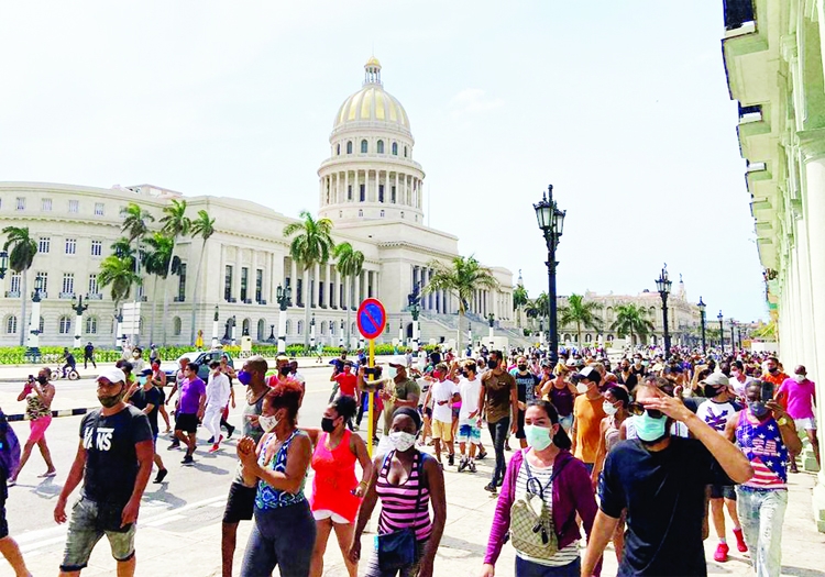 People gather during protests against and in support of the government, amidst the Covid-19 outbreak, outside the Capitol building, in Havana, Cuba.