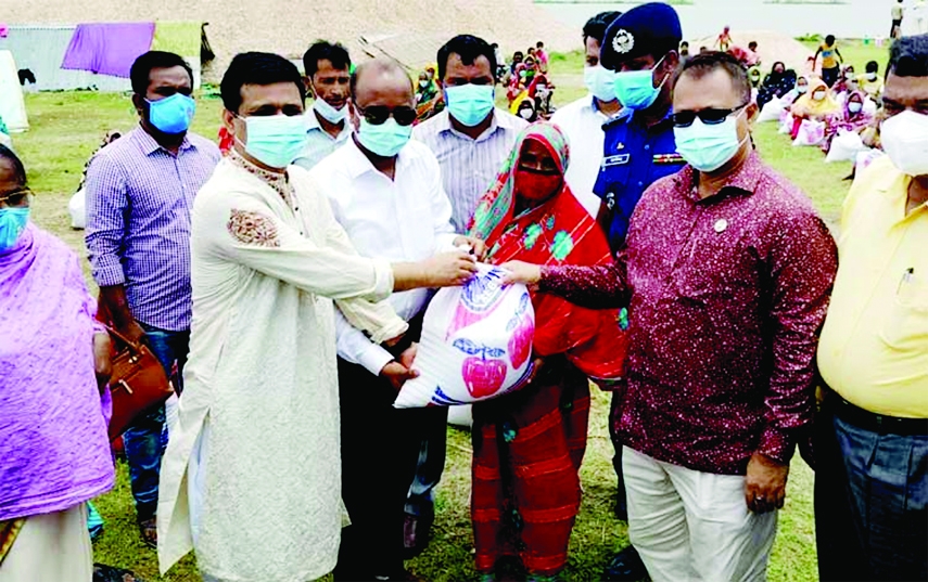 Rejowan Ahamed Tofique, MP at a food distribution ceremony on Friday provides 69 families of Mitamoion Haor President Abdul Hamid model village on the banks of Ghorauttra River in Kishoreganj with relief materials from Prime Minister's fund along with sa