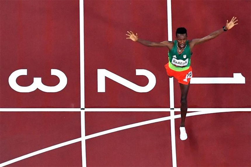 An overview shows Ethiopia's Selemon Barega as he crosses the finish line to win men's 10000m final during the Tokyo Olympic Games at the Olympic Stadium in Tokyo on Friday.