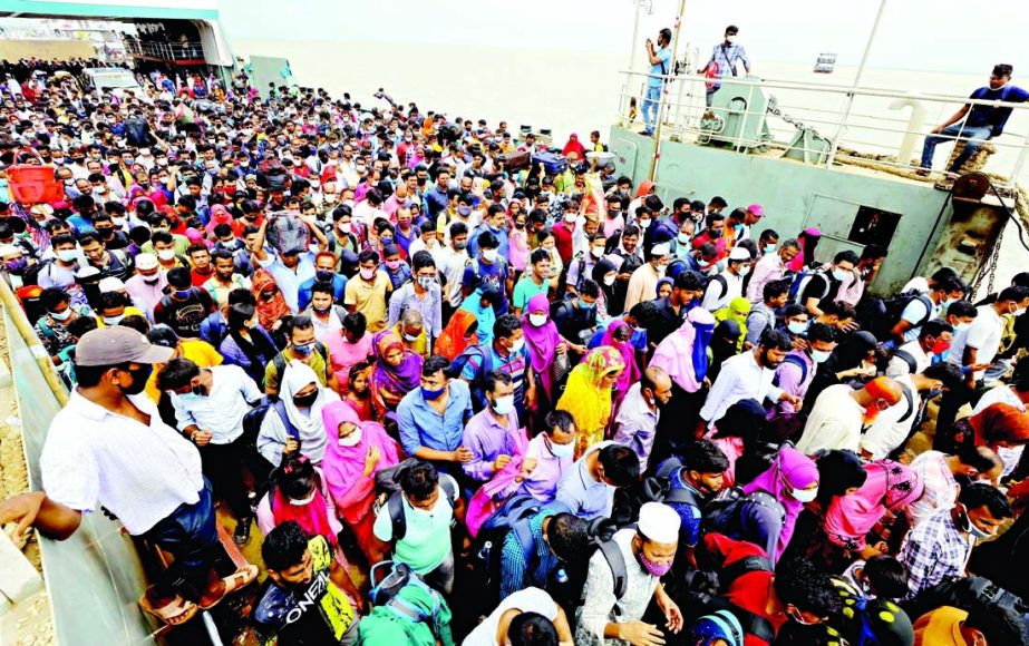People take ride on an overcrowded ferry on way back to Dhaka on Saturday after the authorities announced reopening factories from Sunday.