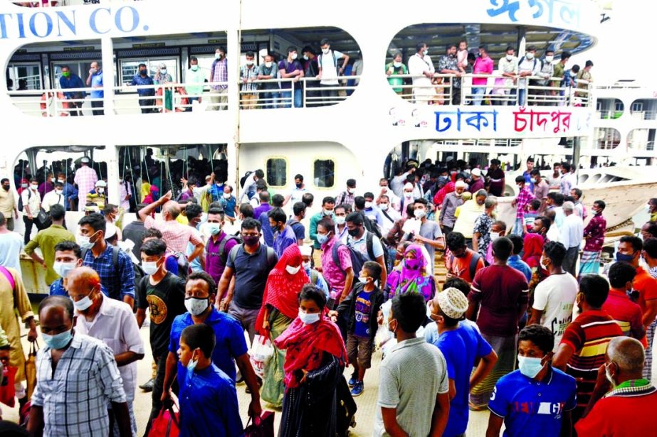 Passengers arrive at the Sadarghat Launch Terminal on Sunday as the government allows limited operation of public transports to help workers to return to work.