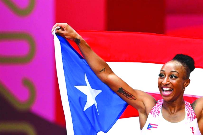 Jasmine Camacho-Quinn of Puerto Rico celebrates with her national flag after winning gold in Tokyo Olympics athletics women's 100m hurdles final at Olympic Stadium, Tokyo, Japan on Monday.