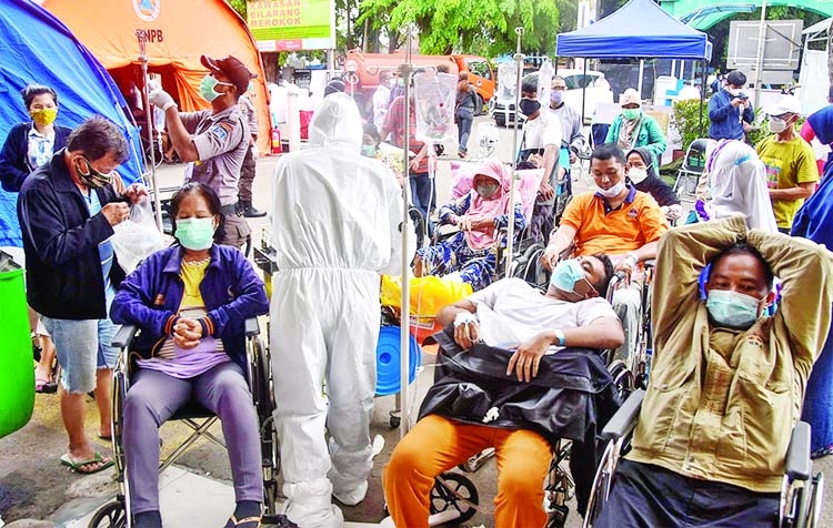 Hospital staff sort out patients suspected of being exposed to coronavirus and others before entering a regional hospital in Bekasi, West Java, Indonesia.