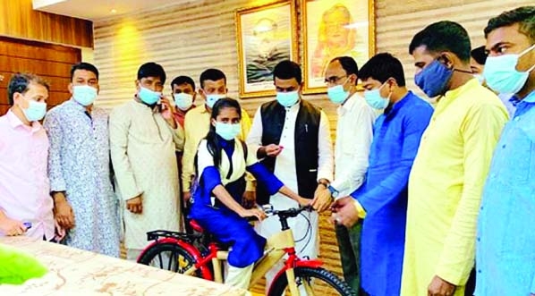 Raozan Pourasava Mayor Jamiruddin Parvez with patronage of Raozan MP ABM Fazle Karim Chowdhury hands over a bicycle to a girl student named Meherunnesa in a ceremony at the pourasava office premises on Sunday. Meherunnesa, a ninth grade student of Salamat