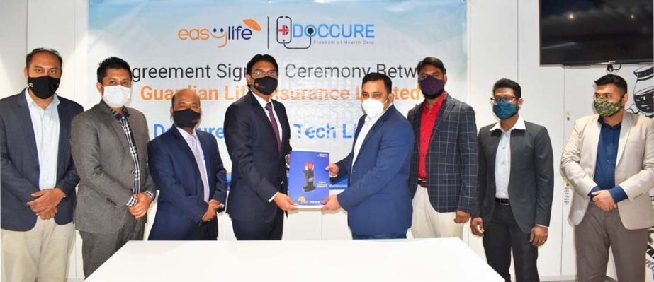 Sheikh Rakibul Karim, CEO of Guardian Life Insurance Limited (GLIL) and Engr. Md. Hafizur Rahman, CEO of DocCure Health Tech Limited, exchanging document after signing an agreement in the capital recently. Under the deal, DocCure Health Tech Limited has j