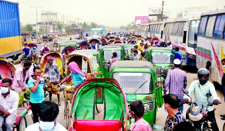 Vehicles are seen clogged in a long traffic congestion on the Dhaka - Chattogram Highway on Monday amid strict lockdown across the country.