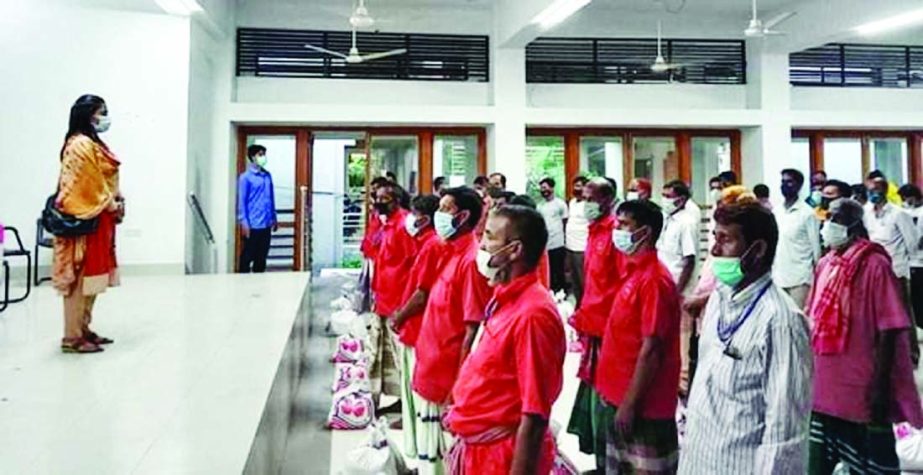 UNO and Executive Magistrate of Bhairab Upazila Lubna Farzana distributes food items, soaps and masks gifted by the Prime Minister for 75 jobless Bhairab Bazar Rail Station workers and destitute people in a formal ceremony at Bhairab Upazila Parishad audi