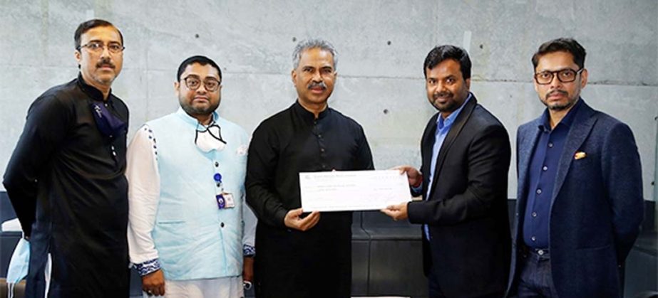 P.K. Saw, General Manager of Epic Group Limited, handing over a cheque of Tk 5 lakh and one lac pieces of face mask to Faruque Hassan, President of BGMEA at its office in the capital on Tuesday. Miran Ali, Vice President and Tanvir Ahmed, Director of BGME