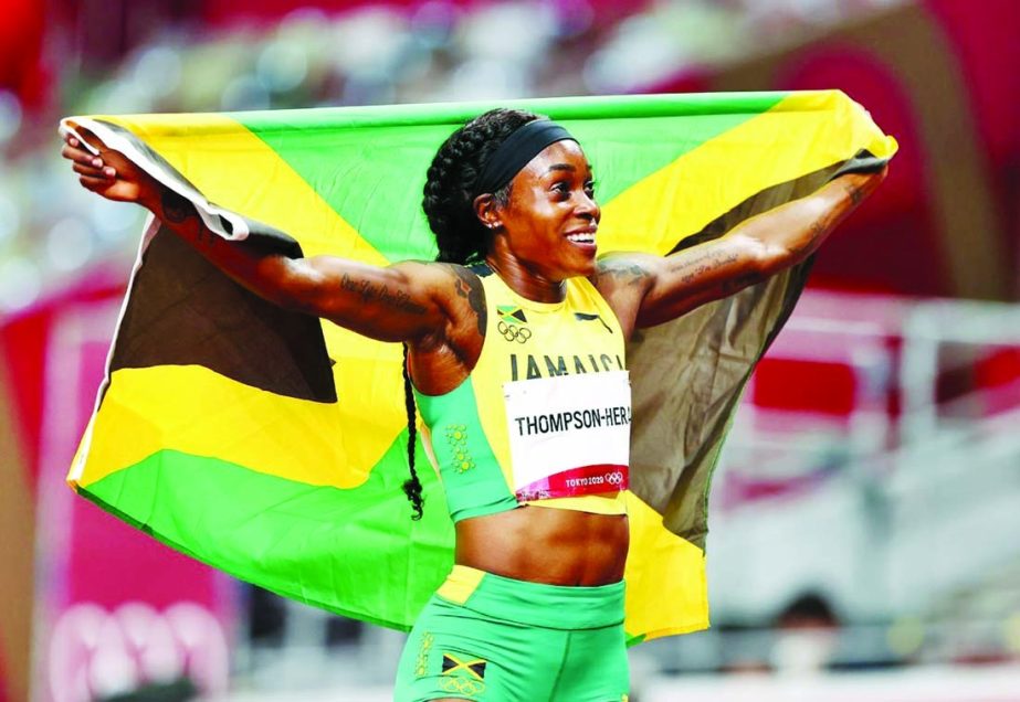 Elaine Thompson-Herah of Jamaica poses with her national flag after winning gold in the Tokyo 2020 Olympics athletics women's 200m at Olympic Stadium in Japan on Tuesday. Agency photo