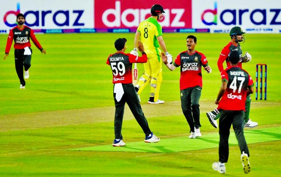 Players of Bangladesh celebrate after the dismissal of an Australian wicket during their first Twenty20 International match at the Sher-e-Bangla National Cricket Stadium in the city's Mirpur on Tuesday.