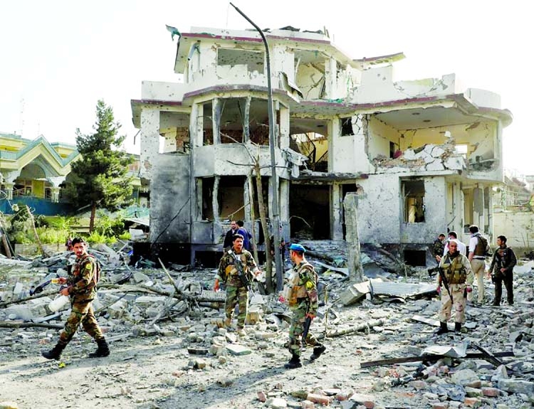 Afghan National Army (ANA) soldiers keep watch a the site of yesterday's night-time car bomb blast in Kabul, Afghanistan on Wednesday.