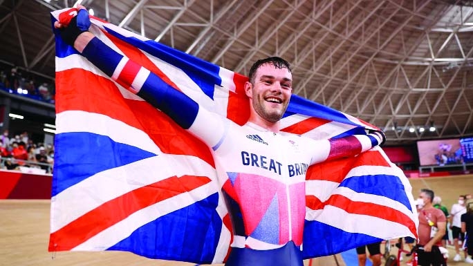 Matt Walls of Britain celebrates winning gold during the Tokyo 2020 Olympics cycling track men's omnium points Race at Izu Velodrome, Shizuoka in Japan on Thursday.