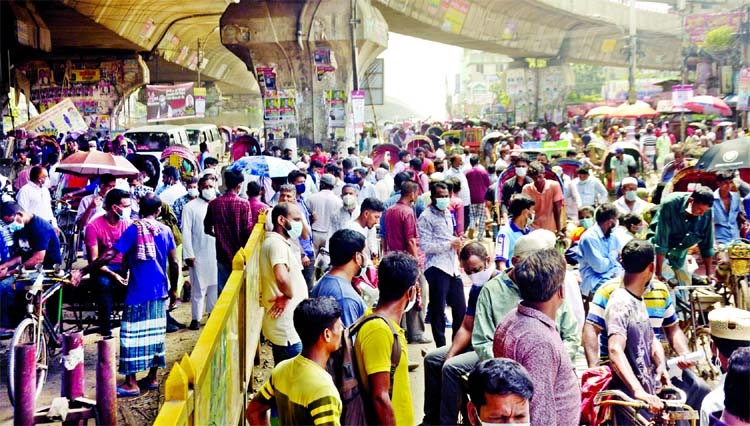 Hundreds of people specially workers of RMG and other export-oriented factories, face huge difficulties to reach their workplaces due to absence of public transports during covid lookdown. This photo was taken from city's Jatrabari area on Thursday.