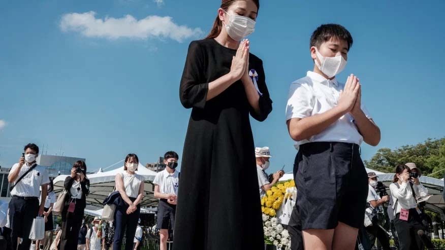 People pray at the Hiroshima Peace Memorial Park in Hiroshima on August 6, 2021, following the annual ceremony to remember the victims on the 76th anniversary of the world’s first atomic bomb attack.