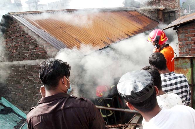 Smoke billows as fire originated at a furniture factory in the city's Jatrabari area on Friday.