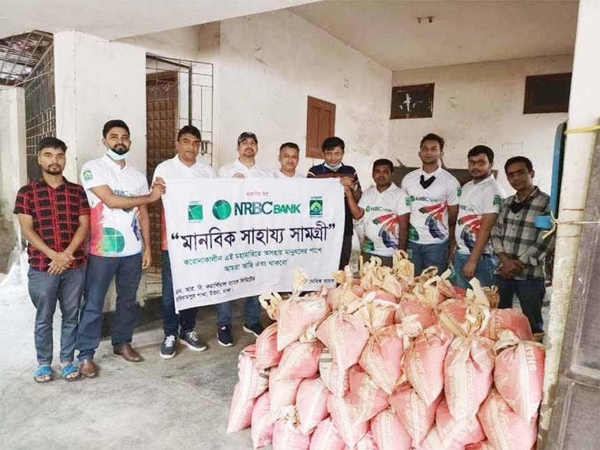 Employees of Harirampur Branch of NRBC Bank distributing food aid to the destitute people of the city’s Uttara area recently.