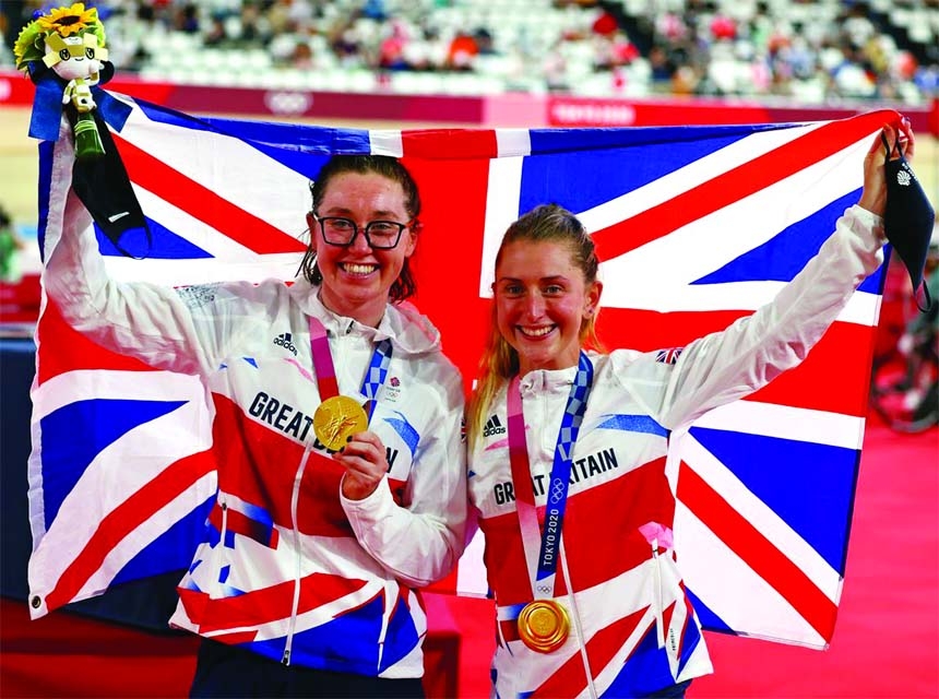 Gold medallists Laura Kenny (right) of Britain and Katie Archibald celebrate on the podium during the Tokyo 2020 Olympics cycling track women's madison at Izu Velodrome, Shizuoka, Japan on Friday.