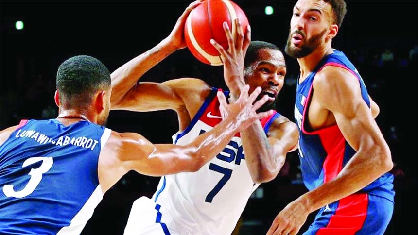 Kevin Durant (center) of the United States in action with Rudy Gobert (right) of France and Timothe Luwawu-Cabarrot of France during the Tokyo 2020 Olympics men's basketball at Saitama Super Arena, Saitama, Japan on Saturday.