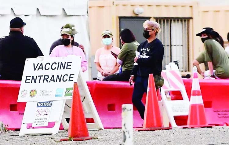 People wearing facemasks outdoors are seen at a Covid-19 vaccine site in Los Angeles, California, US.