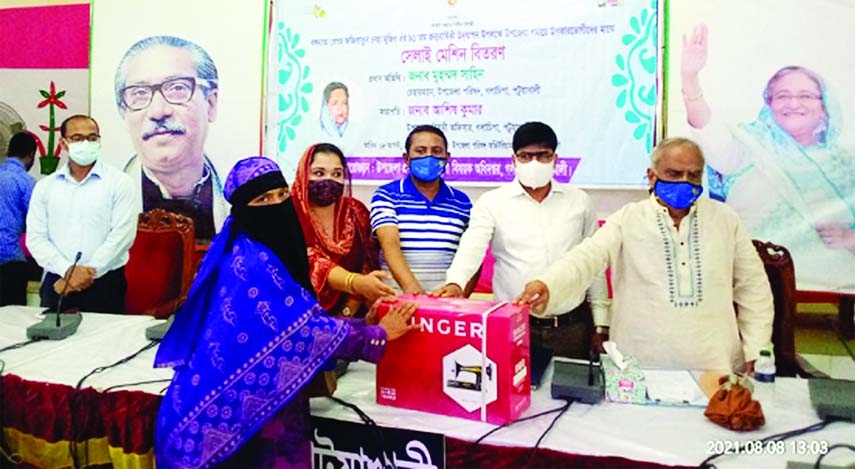 Golachipa Upazila Parishad Chairman Mohamma Shahin distributes sewing machines among women of the upazila to mark the 91st birth anniversary of Bangamata Begum Fazilatunnesa Mujib in a ceremony at his Upazila office on Sunday.