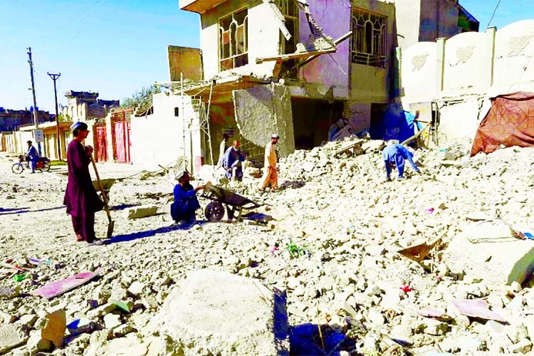 Afghans inspect a damaged building after air attacks in Lashkar Gah, Helmand on Sunday.