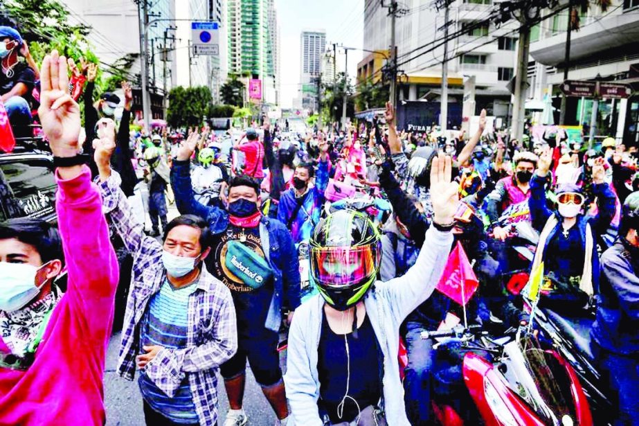 Pro-democracy protesters salute during a car mob protest calling for the resignation of Thailand's prime minister Prayut Chan-ocha over the government's handling of the Covid-19 coronavirus crisis, in Bangkok on Tuesday. Agency photo