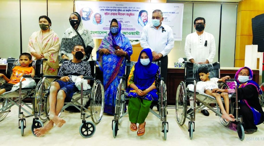 Education Minister Dr. Dipu Moni and Home Minister Asaduzzaman Khan Kamal, among others at the wheel chair distribution among the physically handicapped organised by Awami League at its office in the city's Bangabandhu Avenue on Thursday marking birthday