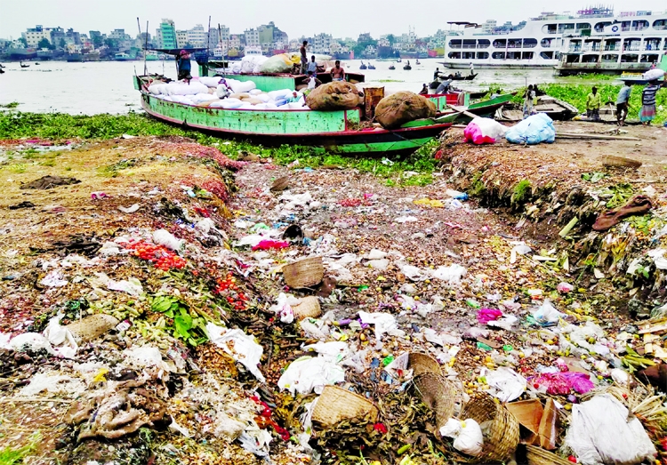 The bank of the Buriganga River is being filled by dumping huge garbage near Shyampur Bazar area in the capital on Friday.