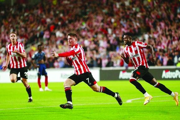 Brentford's Sergi Canos (center) celebrates after scoring the opening goal during the English Premier League soccer match between Brentford and Arsenal at the Brentford Community Stadium in London, England on Friday.