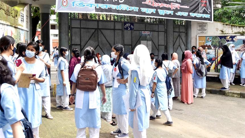 Viqarunnisa Noon School & College students throng at the gate of the institution to take assignments on Saturday.