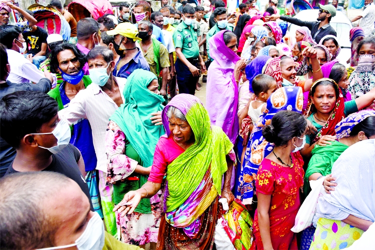 Destitute people crowd at Azimpur area in the capital on Sunday to collect food marking the 46th Martyrdom Anniversary of the Father of the Nation Bangabandhu Sheikh Mujibur Rahman.