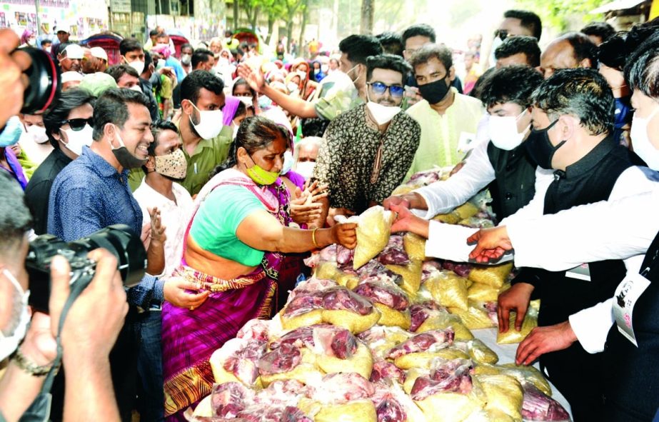 Office Secretary of Bangladesh Awami League Barrister Biplab Barua distributes foodstuff among the distressed at Gowra-a Shah Mazar in the city's Lalbag area on Sunday organised by Councilor of 26 No Ward of DSCC Hasibur Rahman Manik.