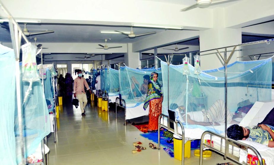 Dengue patients covered with mosquito curtains rest inside the Sir Salimullah Medical College and Hospital in the capital on Tuesday. NN photo